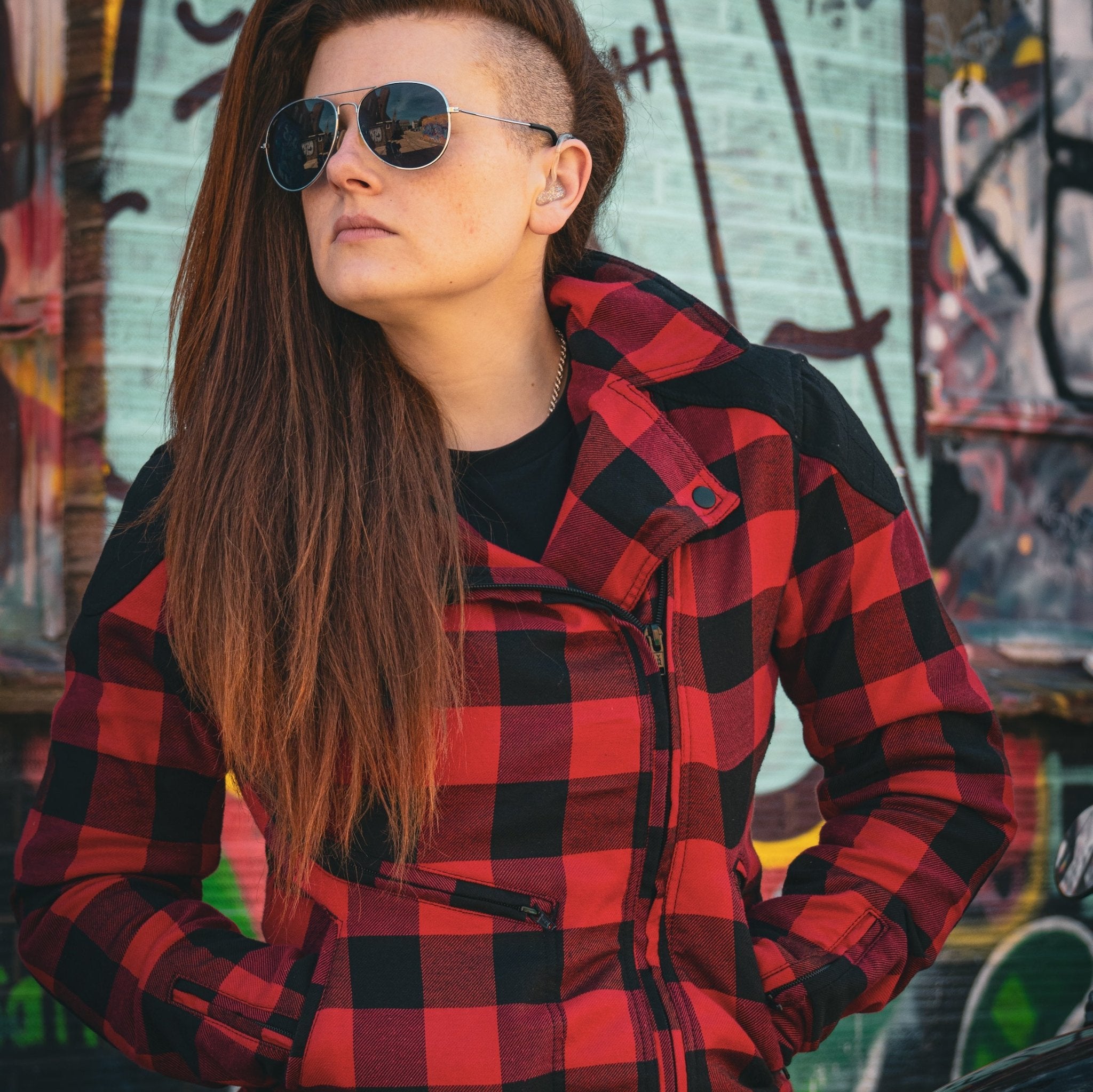 woman with sunglasses wearing  red and black flannel-style women's jacket from moto girl