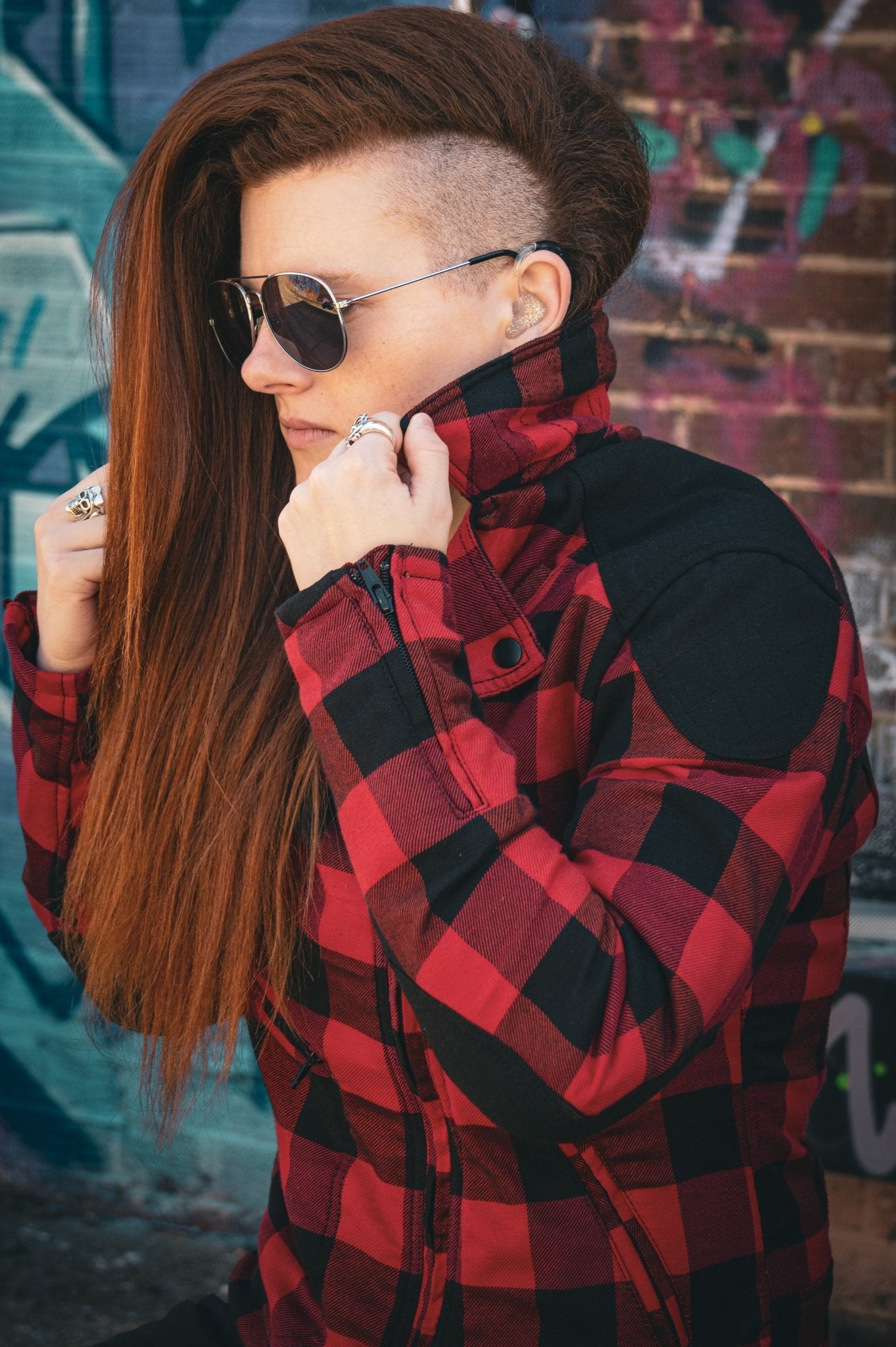 woman with sunglasses wearing  red and black flannel-style women's jacket from moto girl