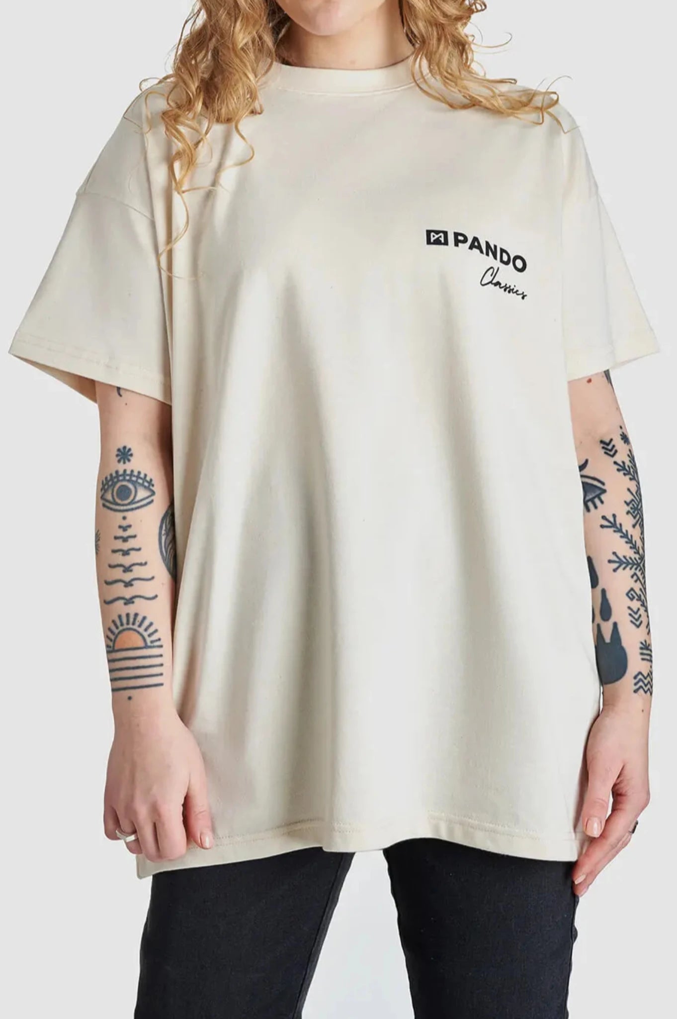 A woman wearing beige motorcycle t-shirt from Pando Moto