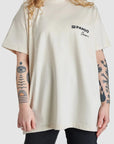A woman wearing beige motorcycle t-shirt from Pando Moto