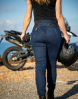 the back of a young woman wearing black  t-shirt and blue jeans