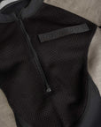 pando logo on a  Black and grey moto bodysuit