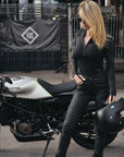 A slim woman wearing slim-fit motorcycle jeans from Pando Moto