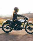 Person riding a motorcycle on a road with a blurred background