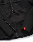 Close-up of a black jacket with a brand logo on a white background