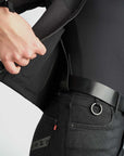 Person wearing a black jacket and pants with a visible brand logo on a white background