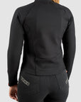 Person wearing a black jacket and pants on a light gray background