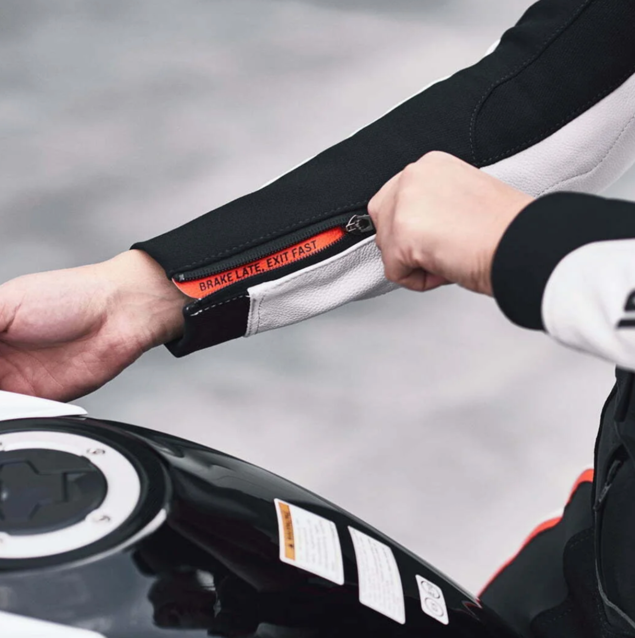 break late, exit fast on the sleeve of a women's motorcycle leather suit