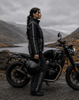 Person with a motorcycle in a mountainous landscape