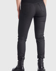 The back of woman's legs wearing slim-fit motorcycle jeans from Pando Moto