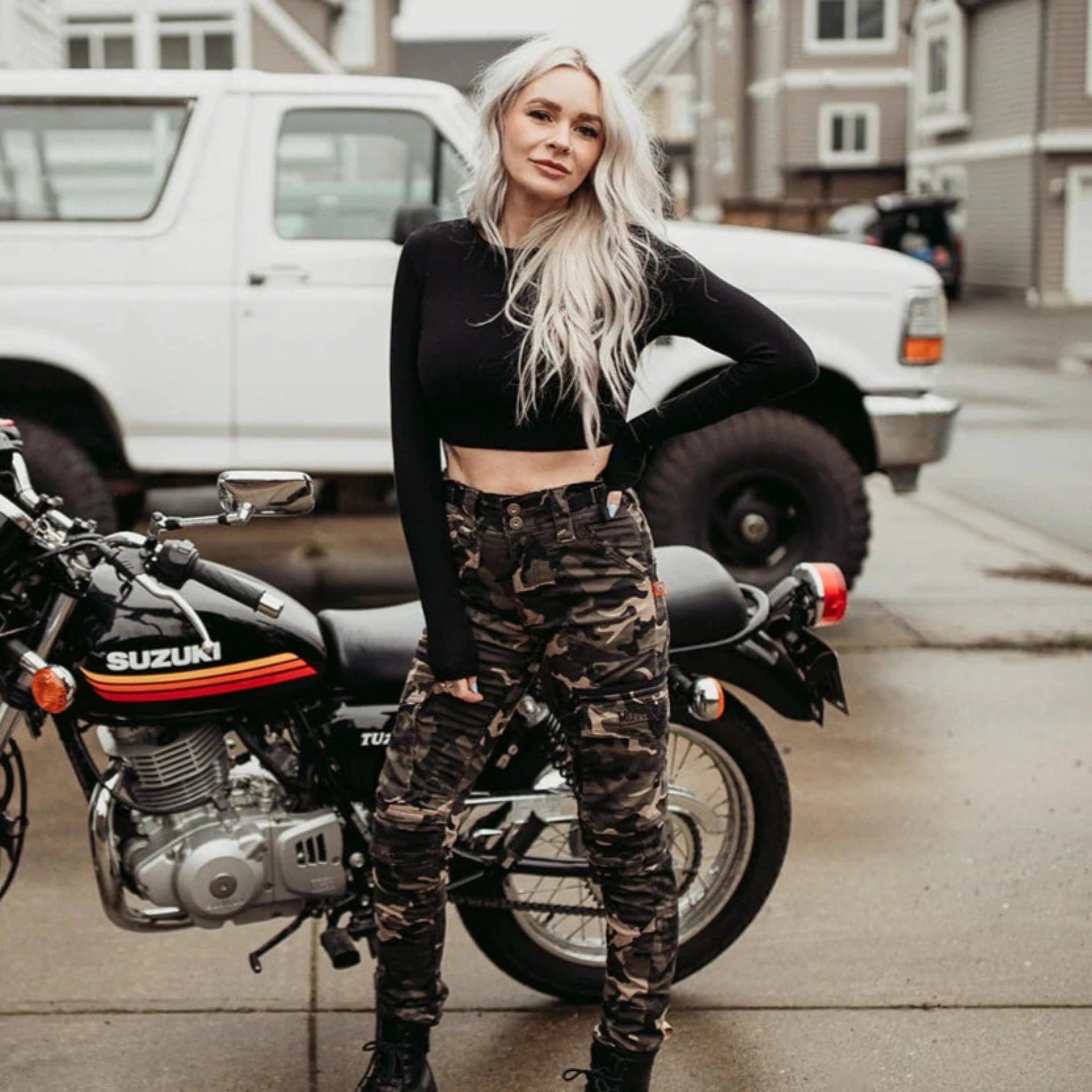 A young blond woman wearing women camouflage motorcycle cargo pants from Moto Girl