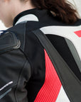A close up of a woman's back wearing Women's racing suit MIURA RS in black, white and fluo from Shima