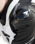 A close up of woman's shoulder wearing Women's racing suit MIURA RS in black, white and fluo from Shima