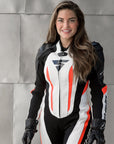 A smiling woman wearing Women's racing suit MIURA RS in black, white and fluo from Shima