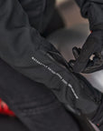 Woman's hands zipping the sleeve of the motorcycle jacket
