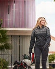 A smiling woman wearing grey women's motorcycle jacket from SHIMA