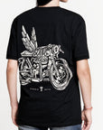 A woman wearing Pando Moto motorcycle t-shirt with the picture of a motorcycle with wings and title that says "going places"