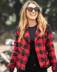 smiling woman with sunglasses wearing  red and black flannel-style women's jacket from moto girl