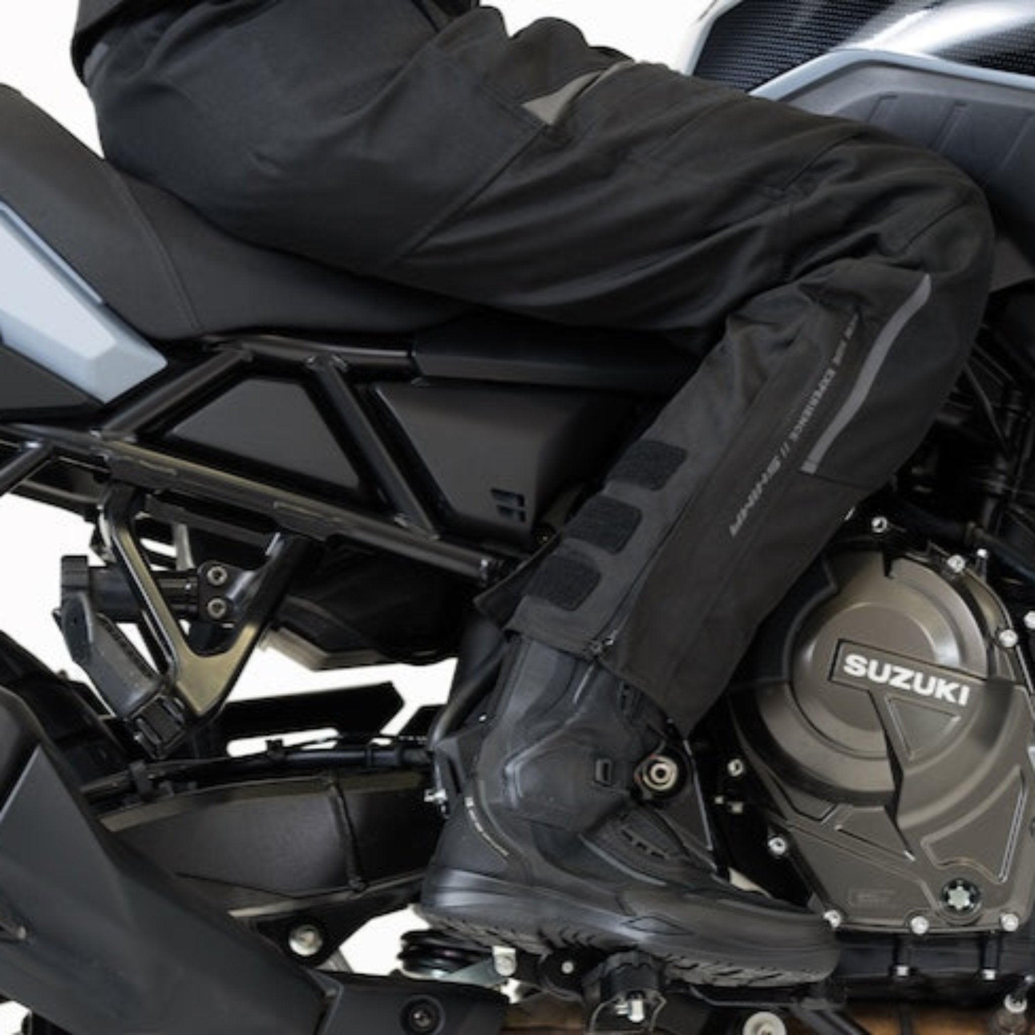 Woman's leg while she sits on her Suzuki motorcycle wearing Shima textile pants