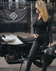 A slim woman wearing slim-fit motorcycle jeans from Pando Moto 