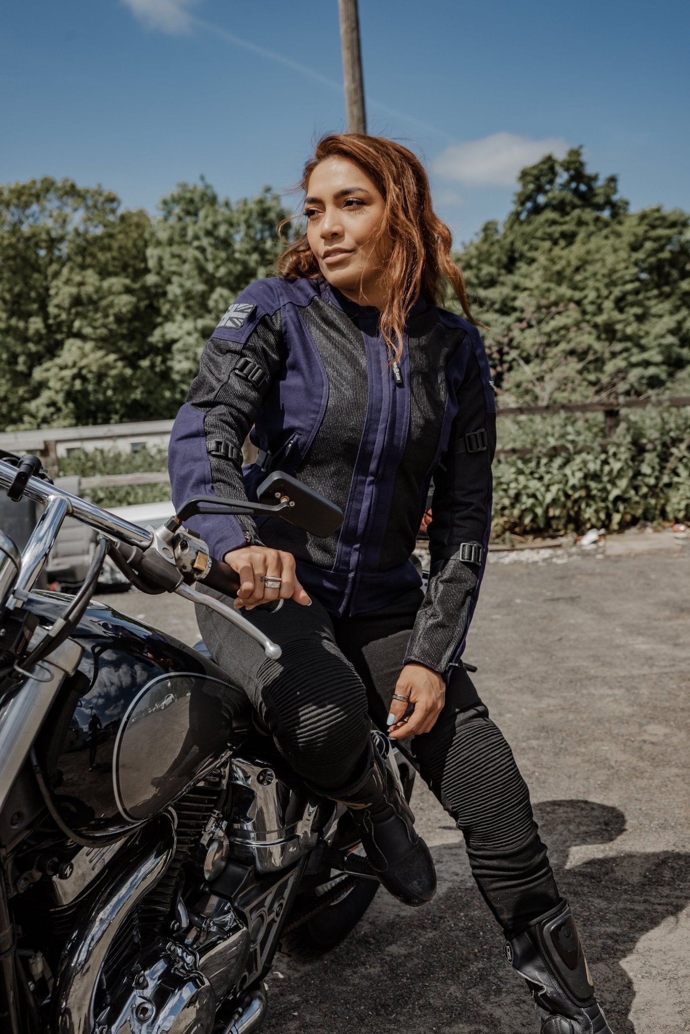 red hair woman sitting on her motorcycle wearing Blue and black women motorcycle mesh jacket from MotoGirl 