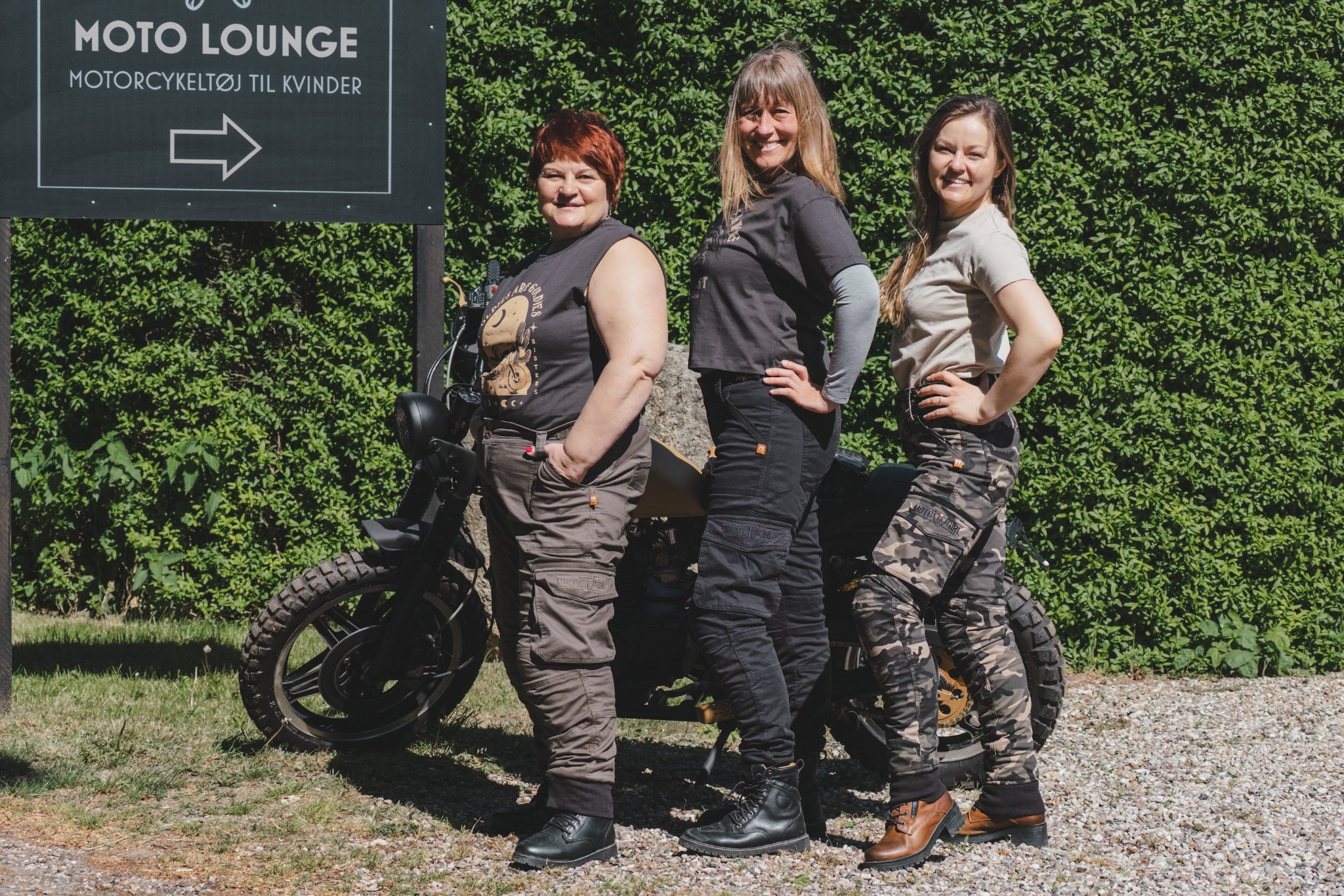 three women of difference sizes demonstrating the motorcycle cargo pants in different colous