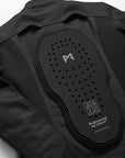 Black protective jacket with a visible brand logo on a white background