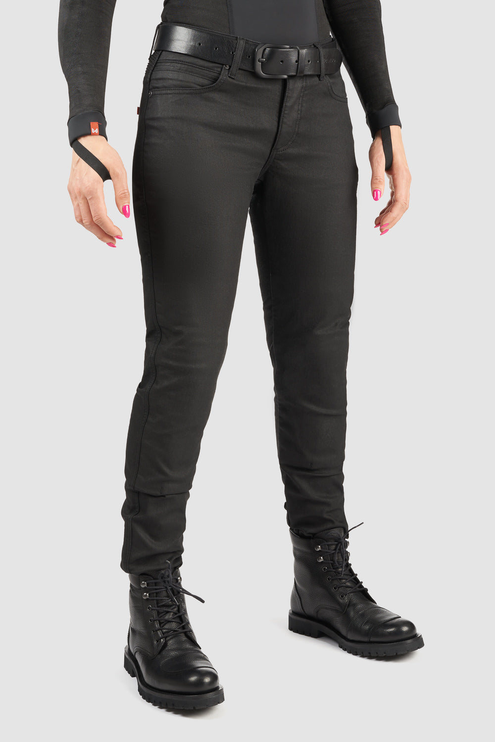 Person wearing black motorcycle pants and black boots on a white background