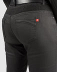 Black mc pants with a red label on the back pocket against a white background