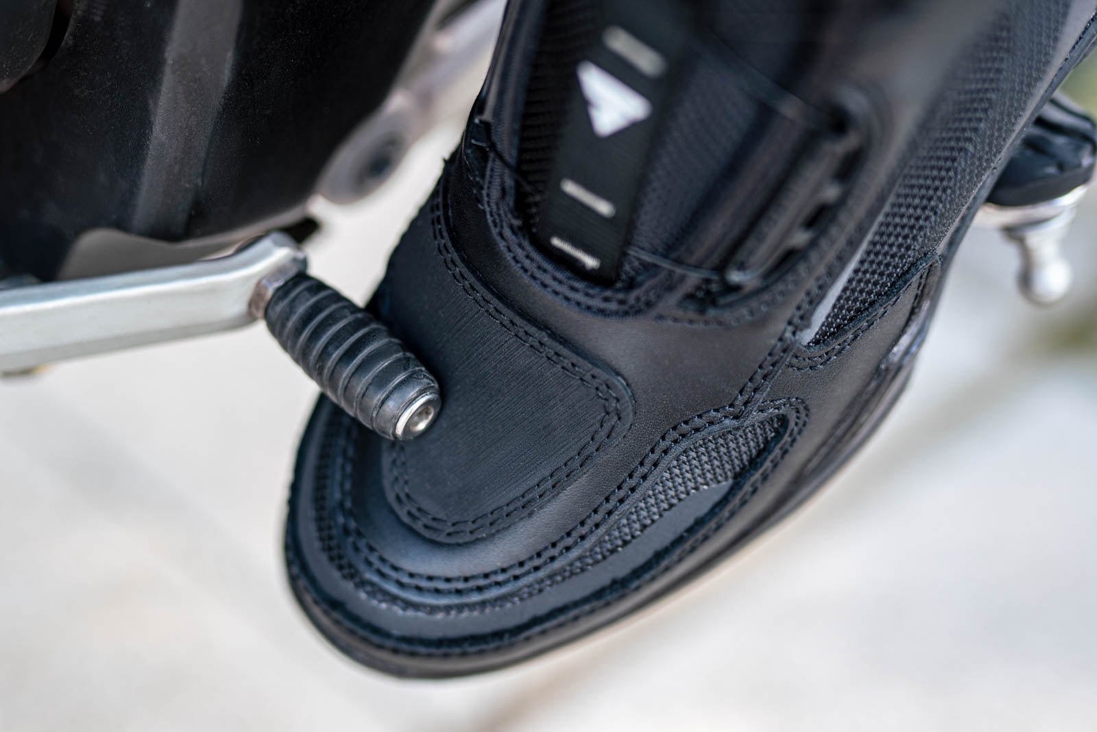 A close up of motorcycle boot changing gears 