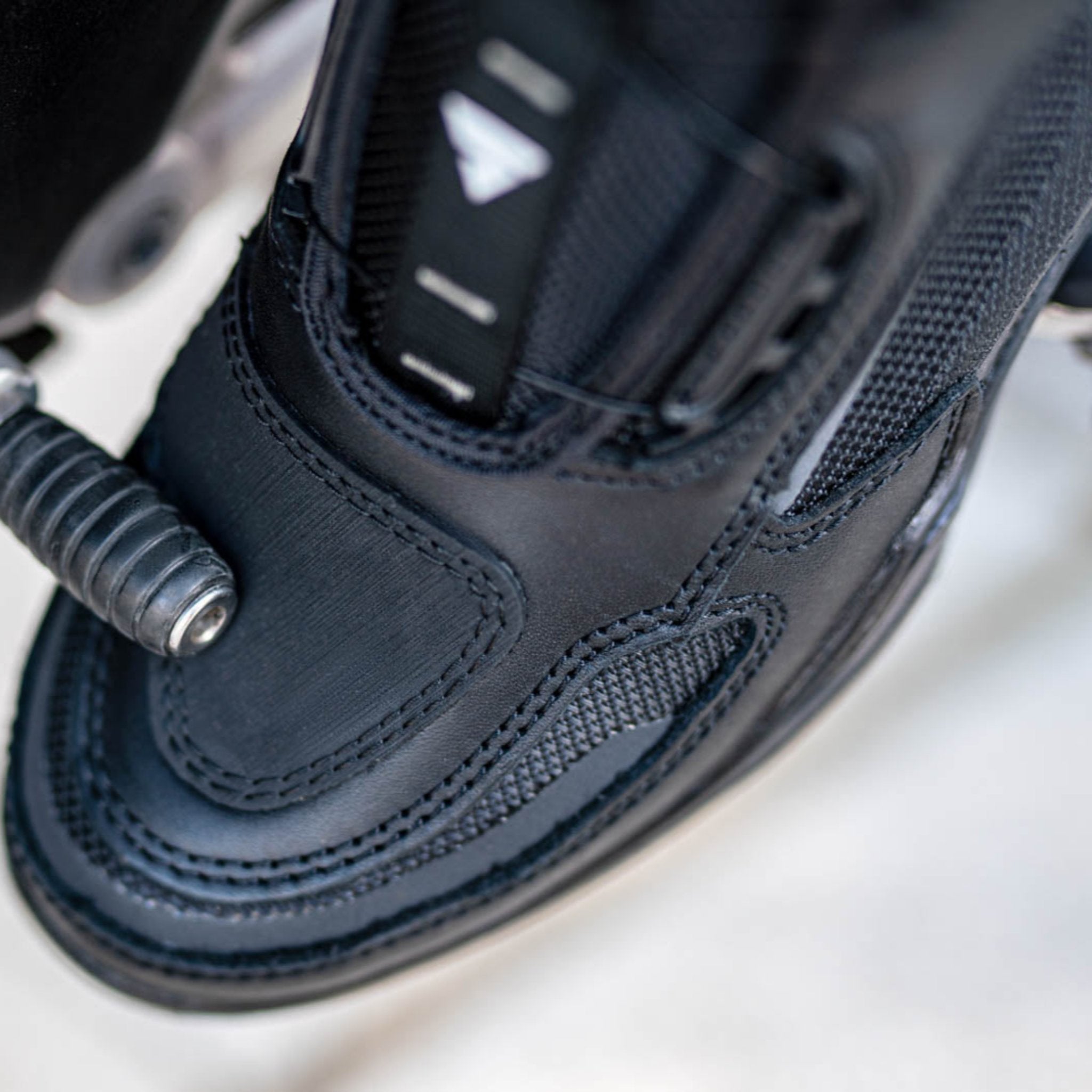 A close up of motorcycle boot changing gears 