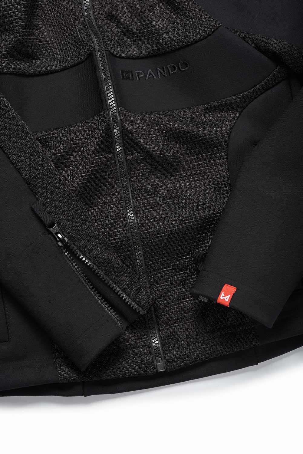 Close-up of a black jacket with a brand logo on a white background