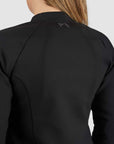 Black blazer with a brand logo on the back, worn by a person.