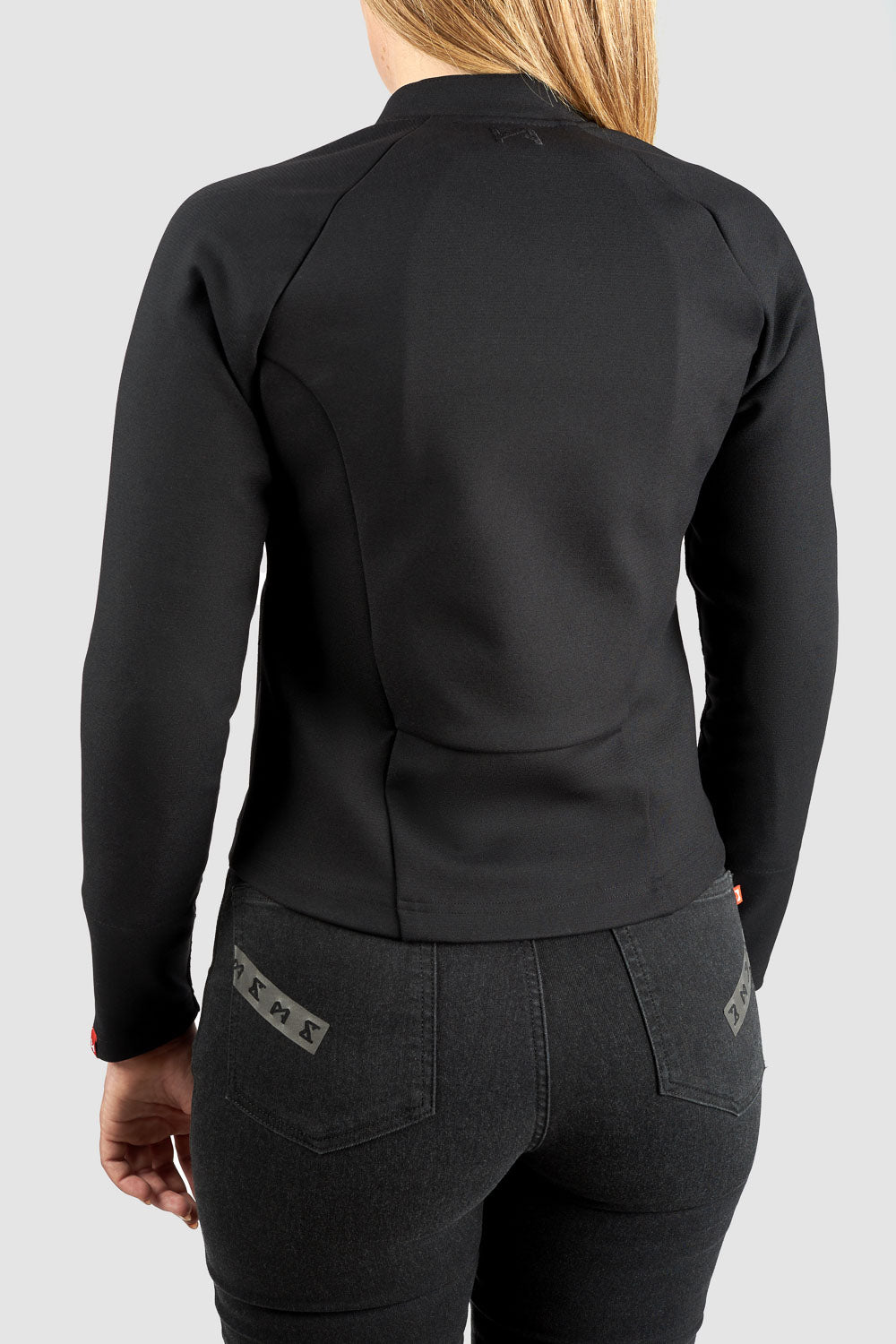 Person wearing a black jacket and pants on a light gray background