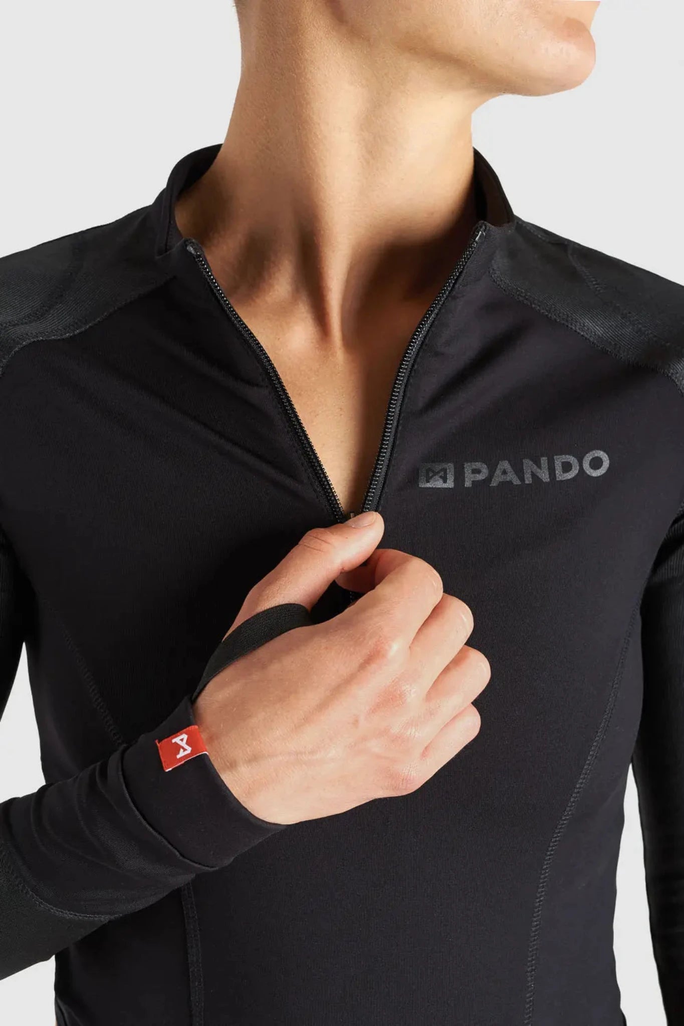 A close up of the neck zipper of Pando Moto Armored motorcycle long-sleeve bodysuit base layer for women