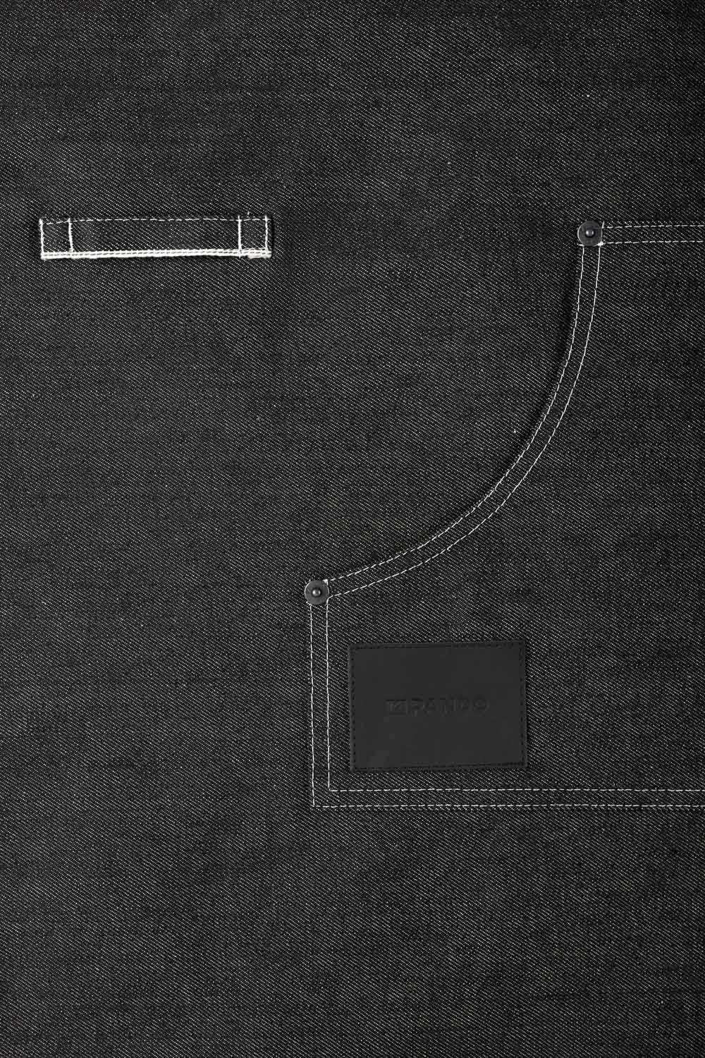 A close up of a pocket of a black denim apron Pando Moto 