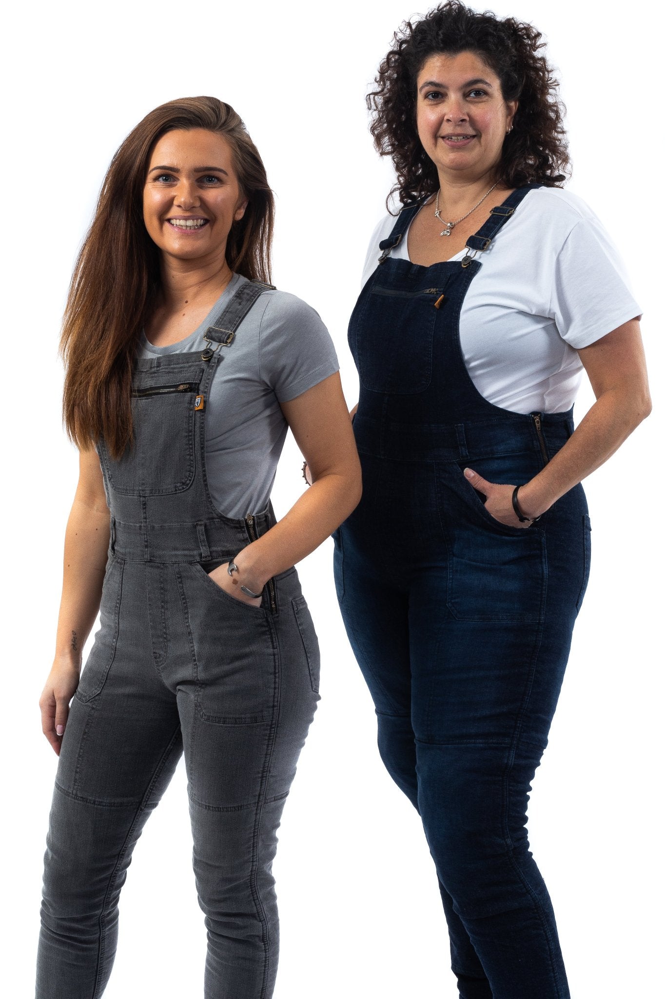 Two women wearing kevlar motorcycle overalls in the colors grey and blue for women from Motogirl