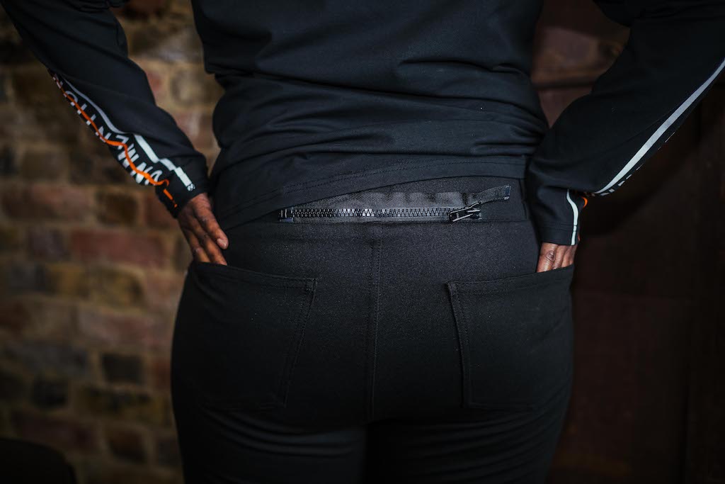 A woman's back with  black leggings and sweatshirt