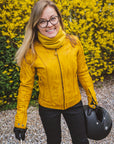 A smiling woman wearing yellow women's motorcycle leather jacket 
