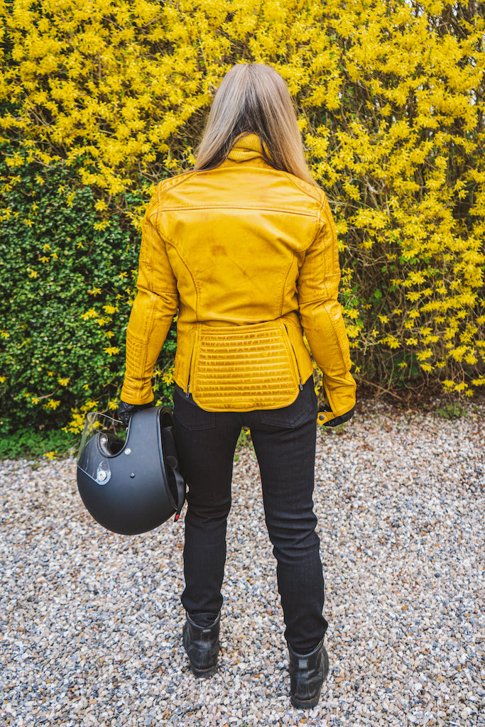 Woman&#39;s back wearing yellow women&#39;s motorcycle jacket