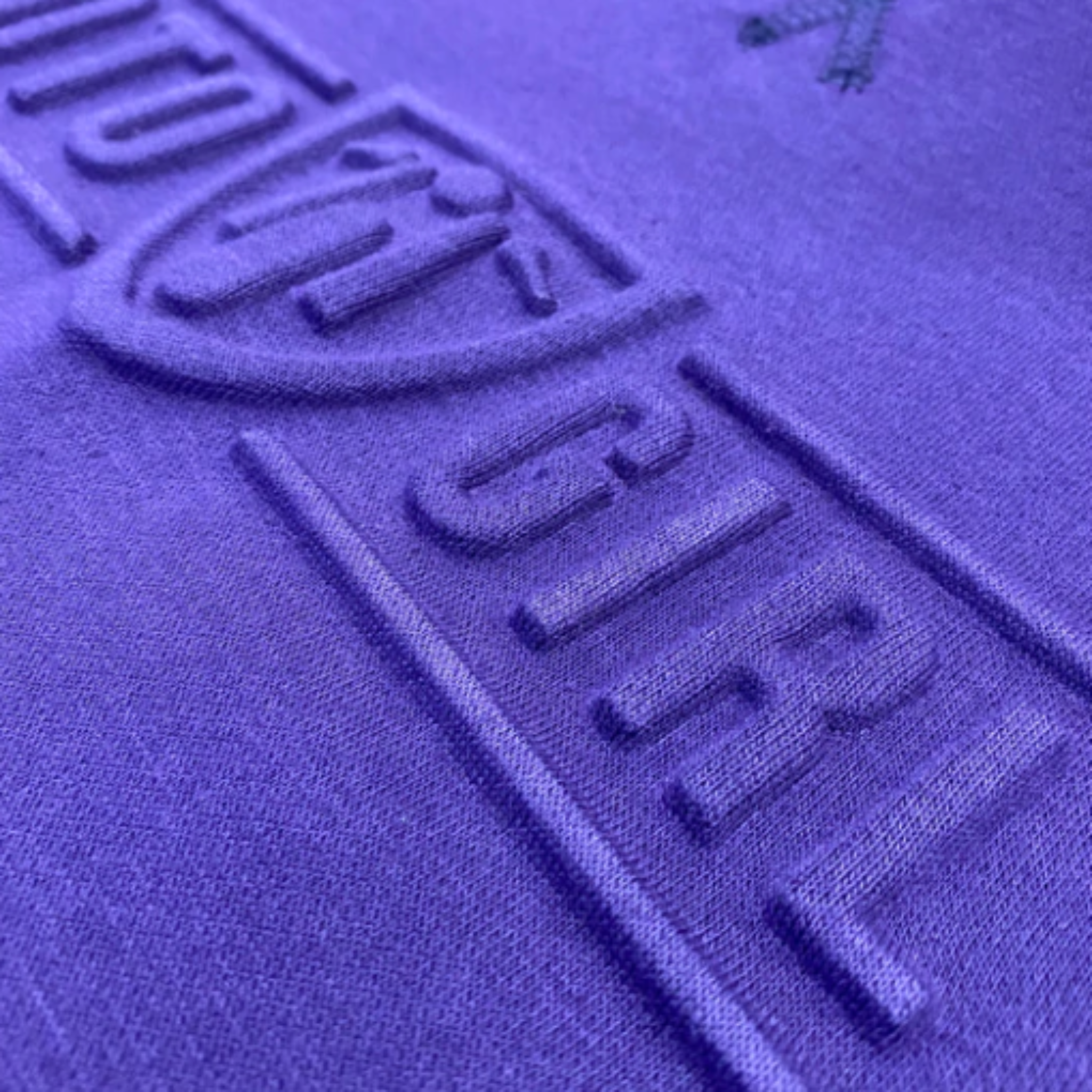 A close up of the 3d logo on a women&#39;s motorcycle sweatshirt from Moto Girl in the color purple 