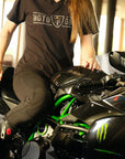 A woman on a motorcycle wearing motorcycle leggings and MotoGirl Tshirt