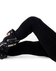 Woman's legs wearing motorcycle leggings and boots  
