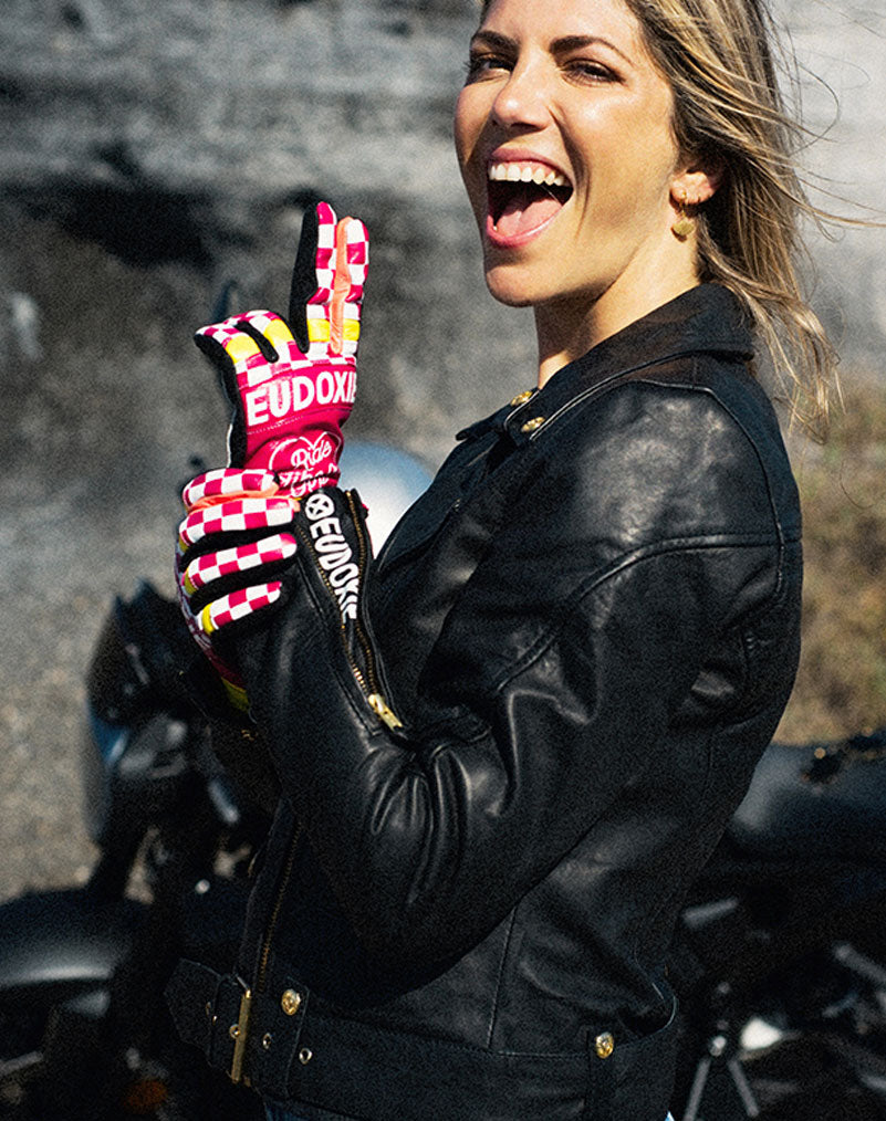 A woman wearing Ride like a Girl pink, black and yellow women's motorcycle gloves from eudoxie