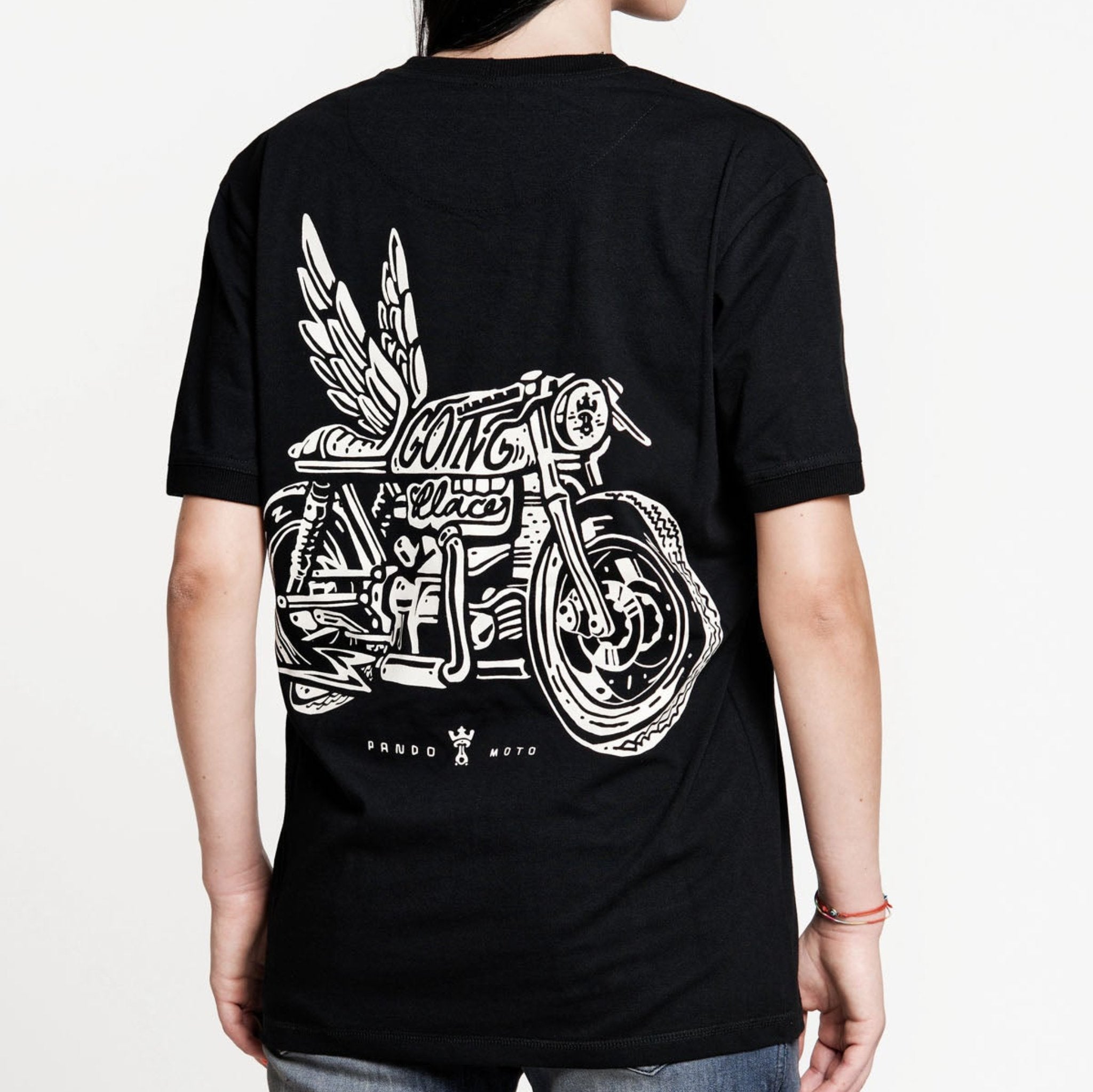 A woman wearing Pando Moto motorcycle t-shirt with the picture of a motorcycle with wings and title that says "going places"